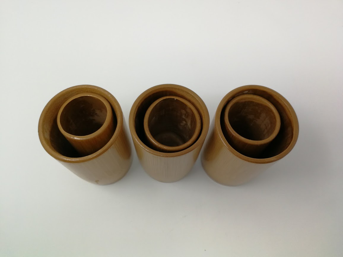 Six brown cylindrical objects on a white background