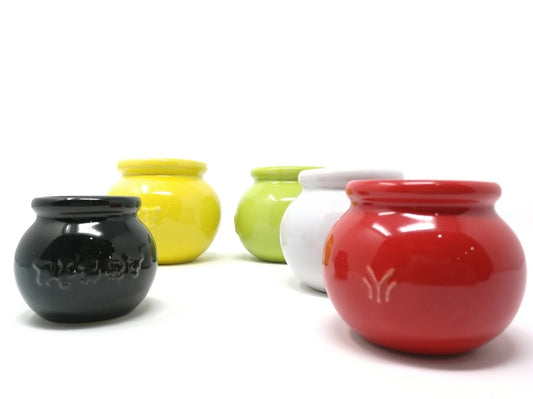 Set of colorful ceramic cups on a white background