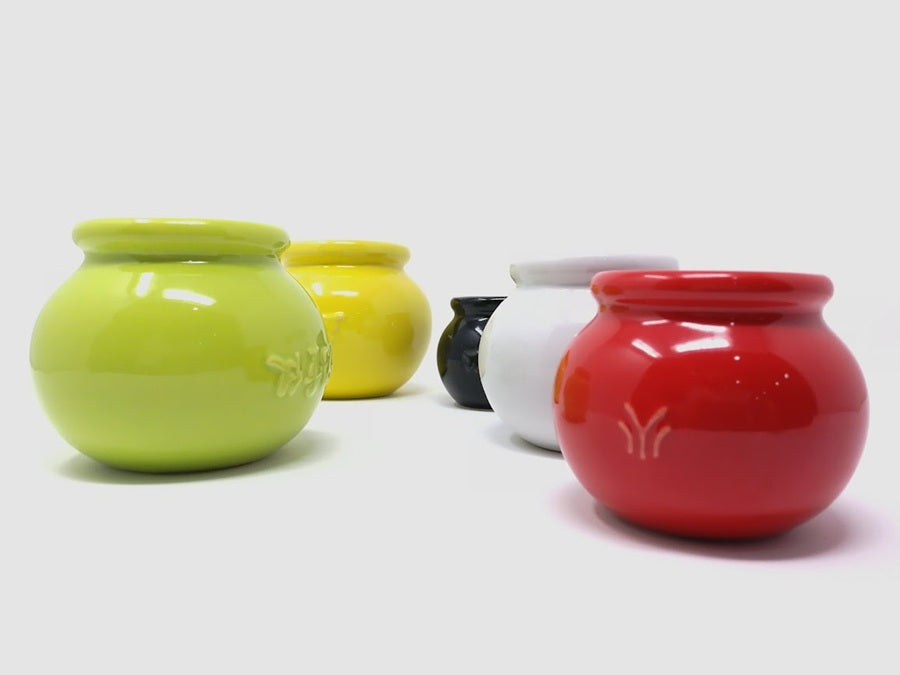Set of colorful ceramic cups on a white background