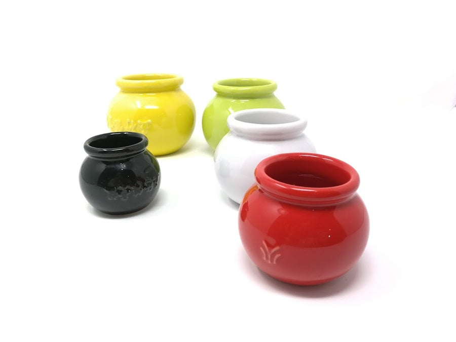 Five colorful ceramic cups on a white background