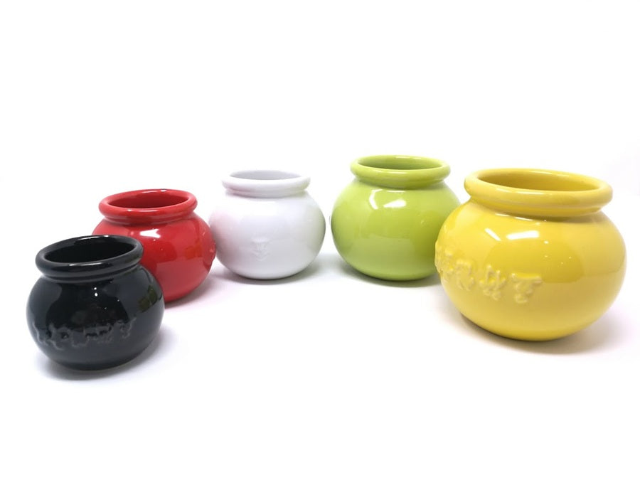 Set of five colorful ceramic cups on a white background