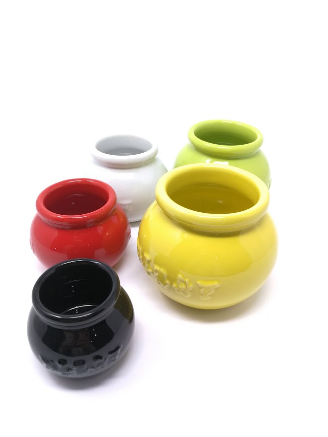 Set of colorful ceramic cups on a white background