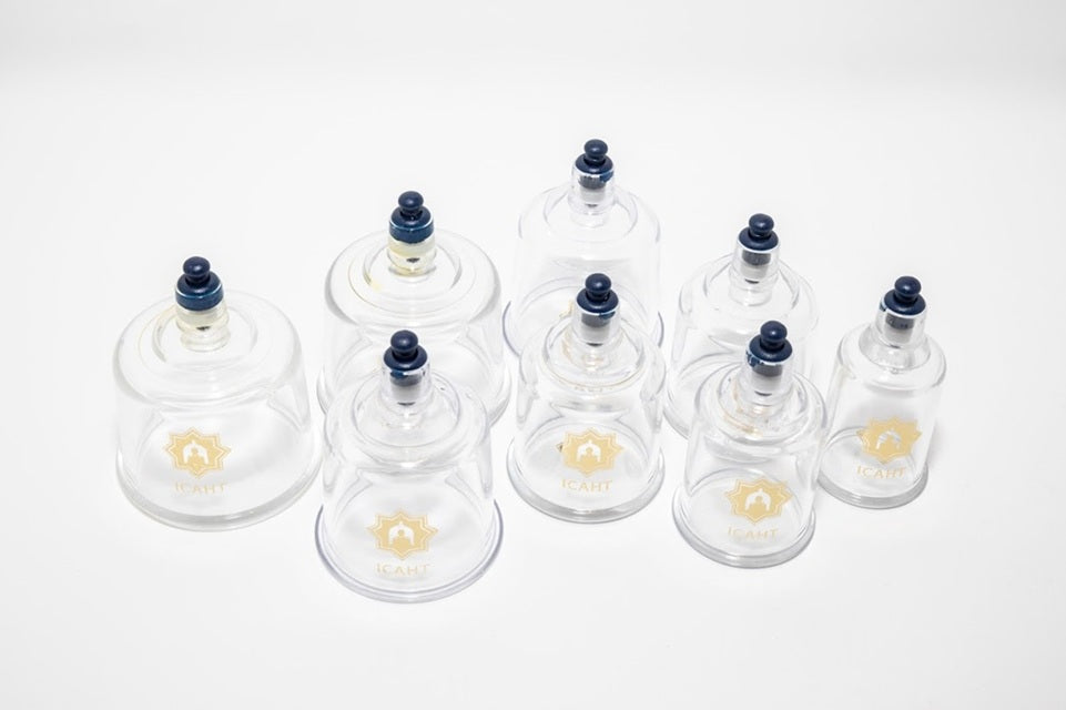 Set of glass cupping jars with black nozzles on a white background