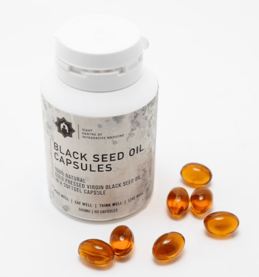 Black seed oil capsules with a container on a white background