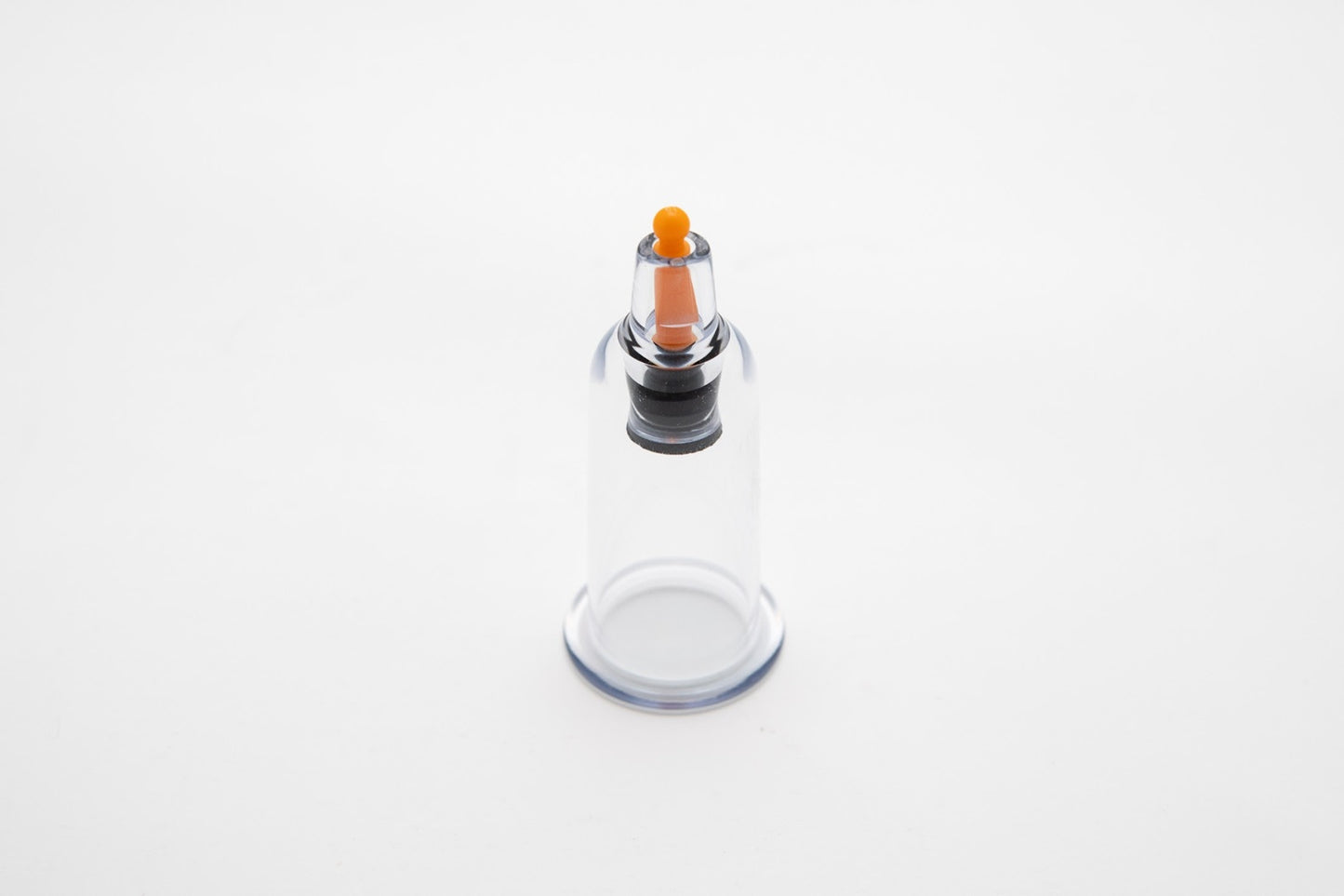 Clear glass bottle with an air release button at the upper middle part on a white background