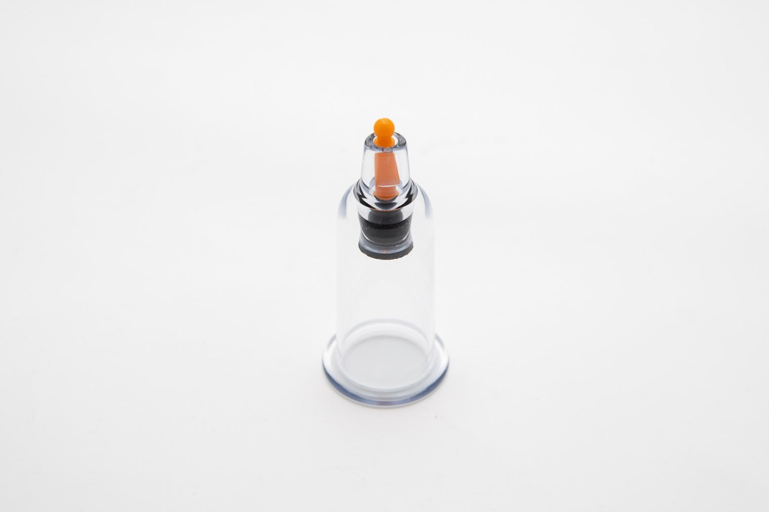 Clear glass bottle with an air release button at the upper middle part on a white background