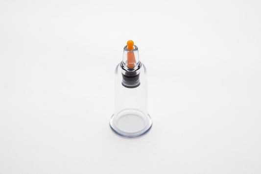 Clear glass bottle with an air release button at the upper middle part on a white background
