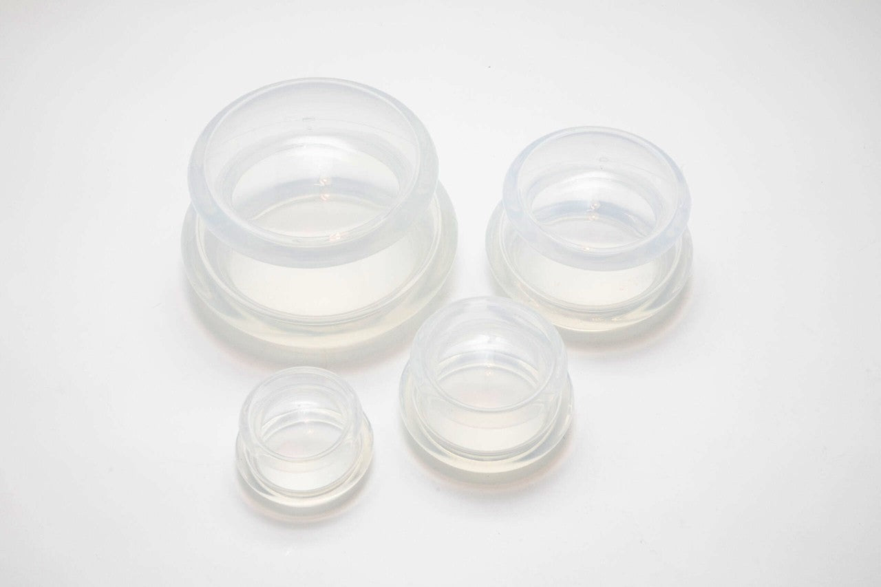 Set of clear silicone cups on a white background